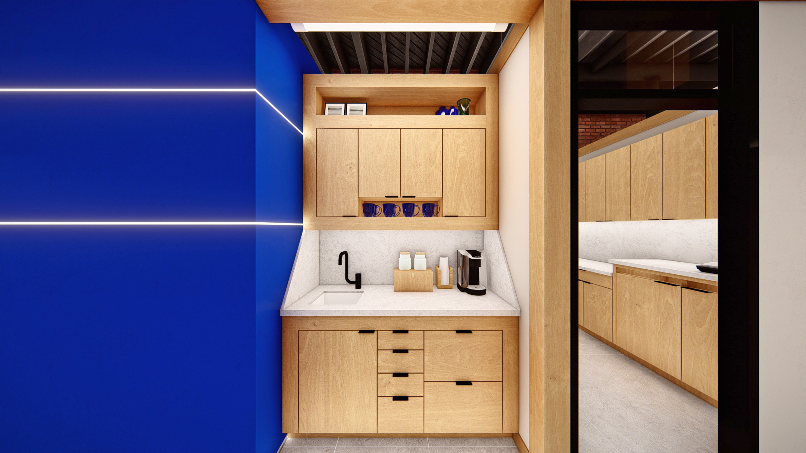 Compact kitchenette at Coldwell Banker in The Shops, Coeur d'Alene, Idaho, featuring warm wood cabinetry, a white quartz countertop and backsplash, a matte black faucet, and a vivid cobalt blue accent wall with horizontal LED light strips.