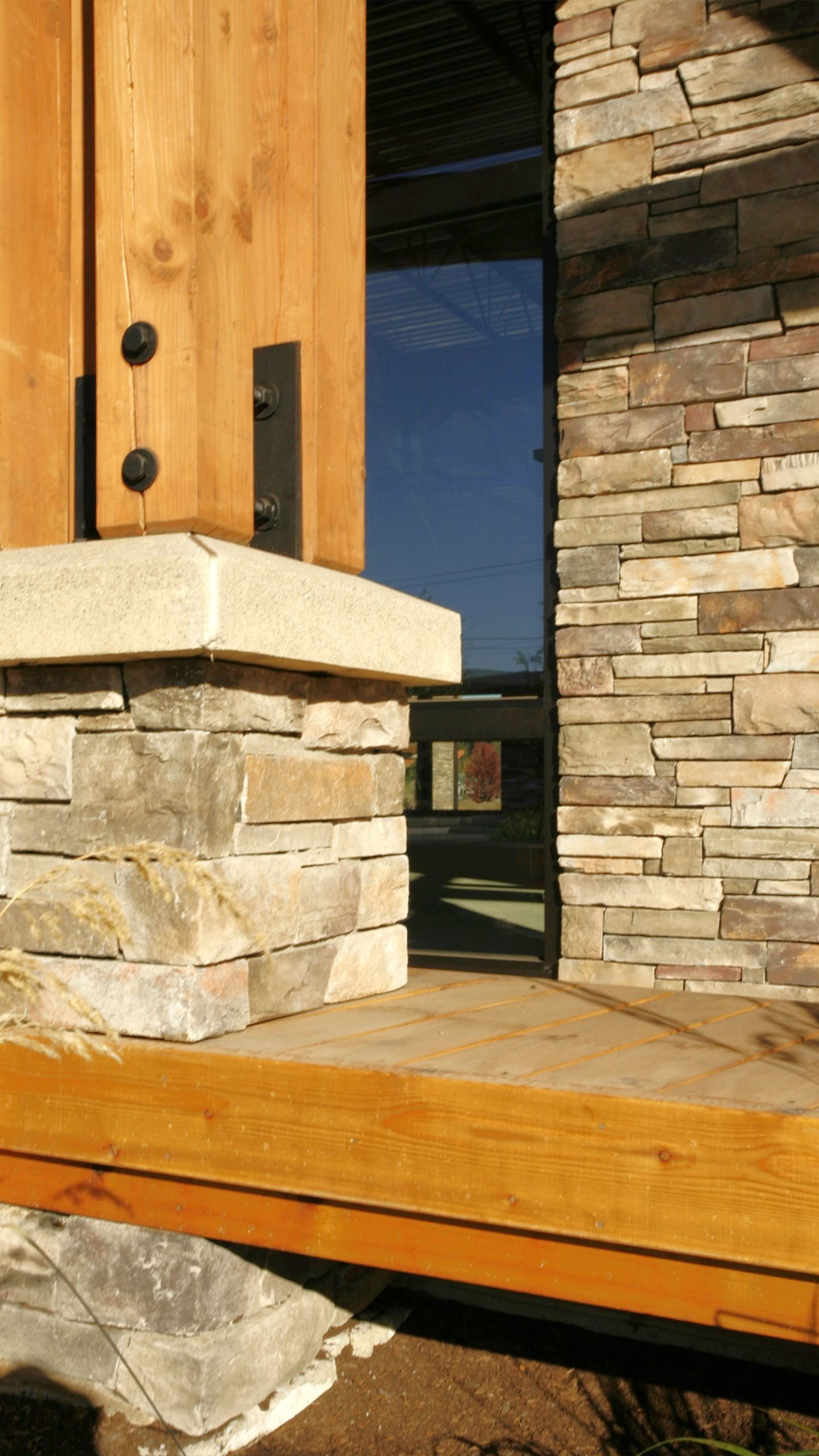 Detail of wood, steel, and stone construction at Hayden Creek Plaza in Hayden, Idaho, highlighting craftsmanship and material contrast.